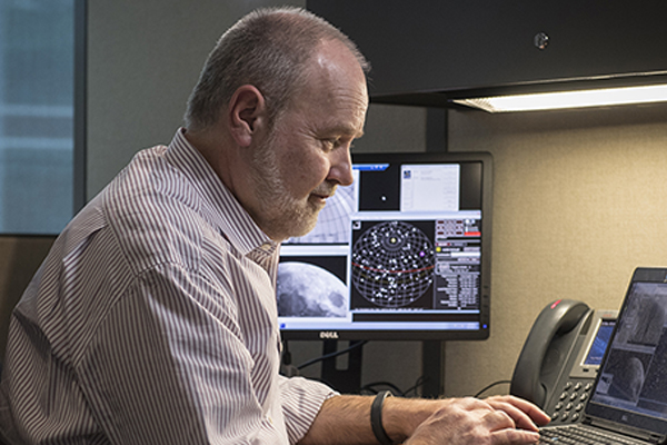 Dr. Ed Albin controls the telescope from his computer.