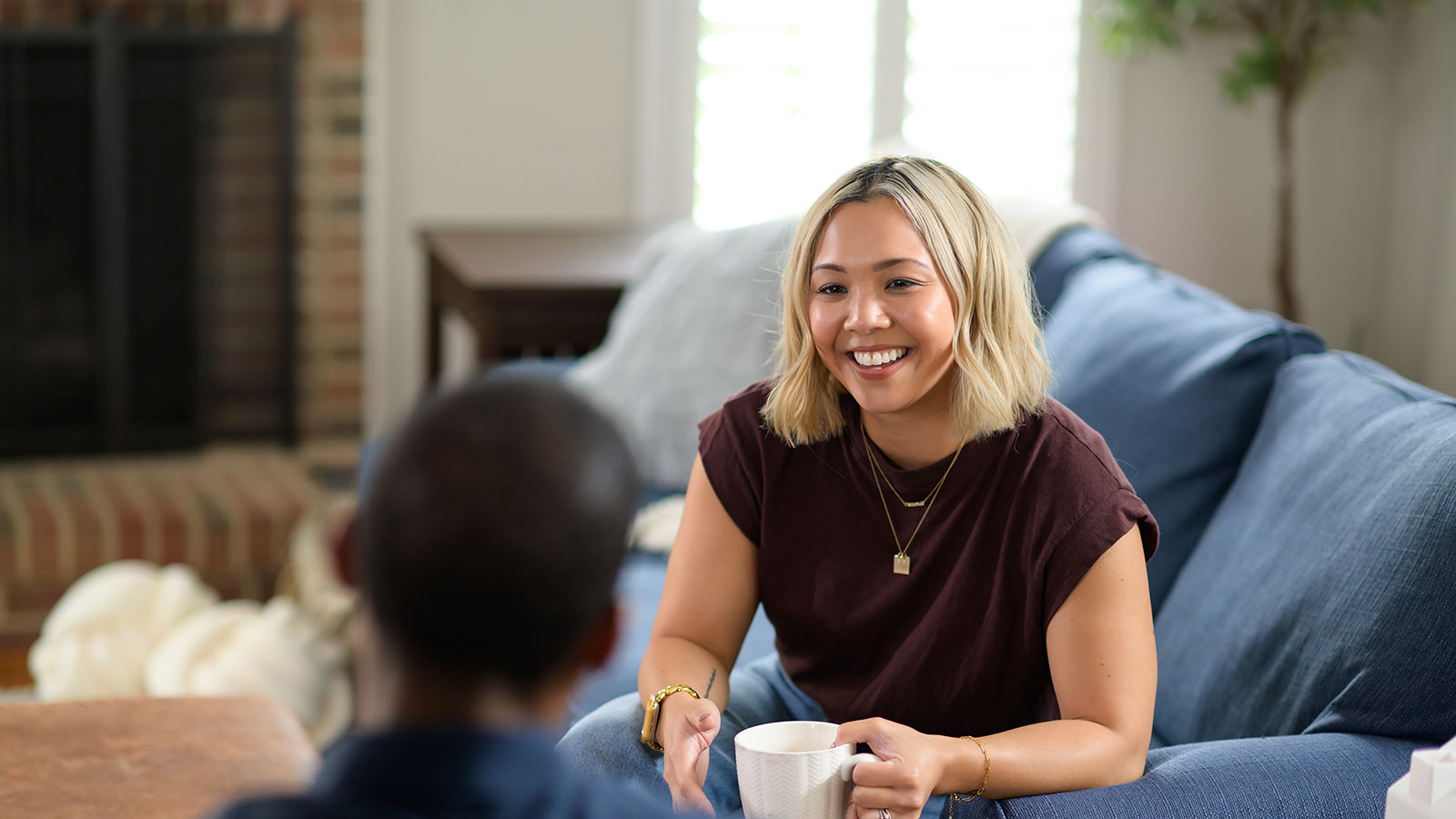 student drinking coffee on couch